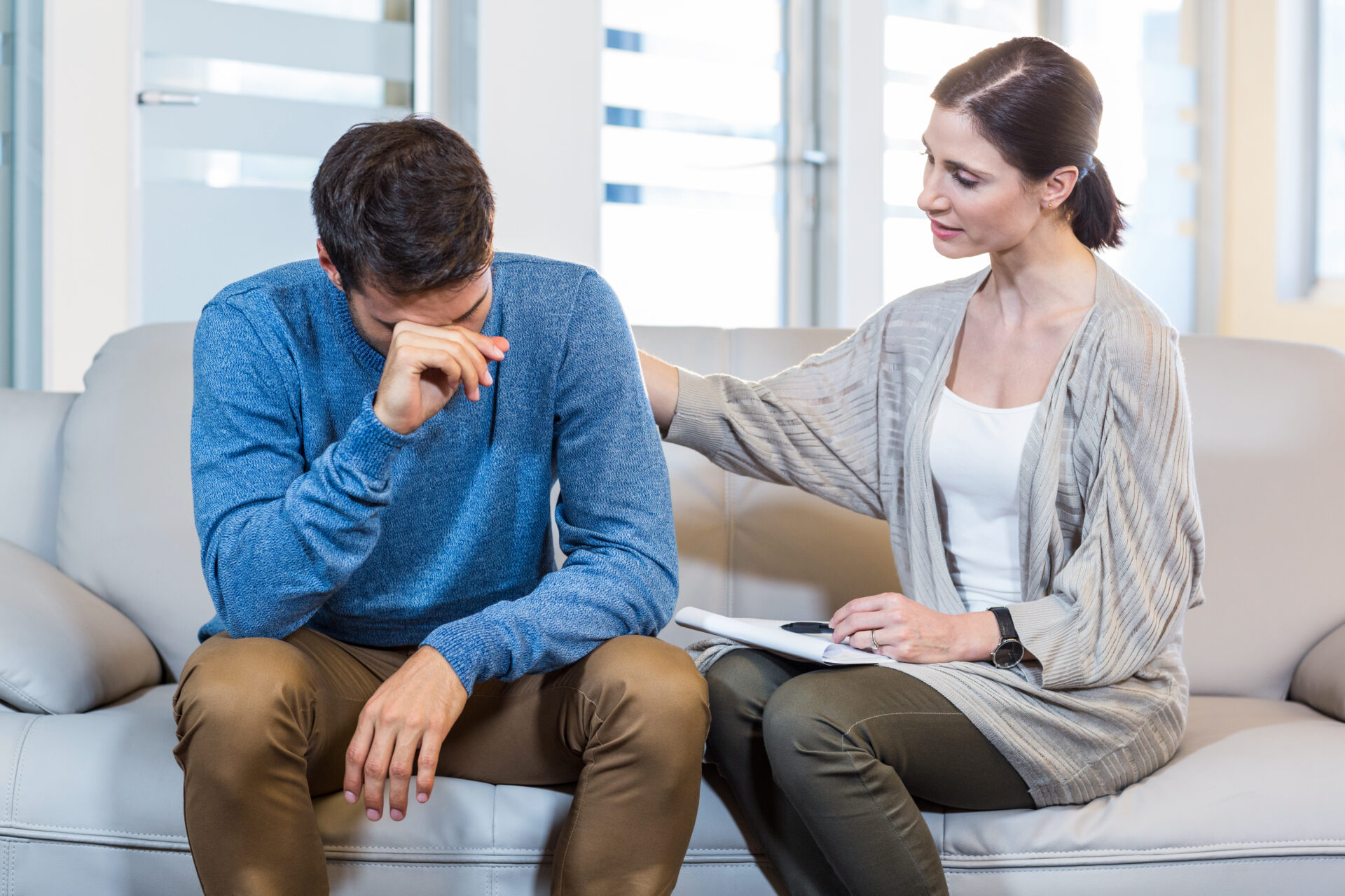 Psychologist comforting a depressed man in the office